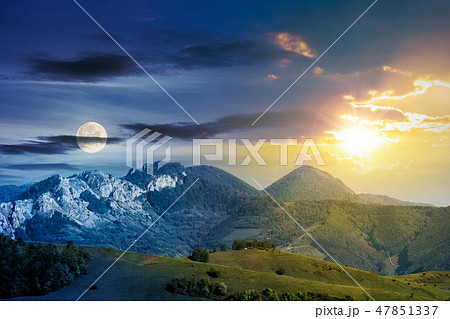 time change above mountains with rocky formations 47851337