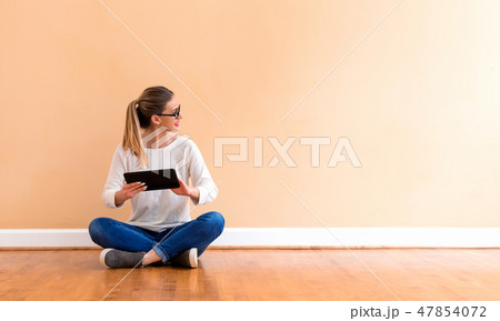 Young woman with a tablet computer Young woman with a tablet computer 47854072