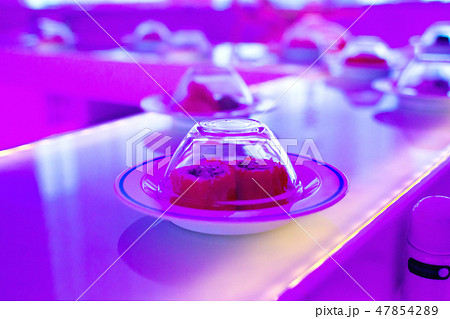 Conveyor serving sushi. Neon-purple lights 47854289