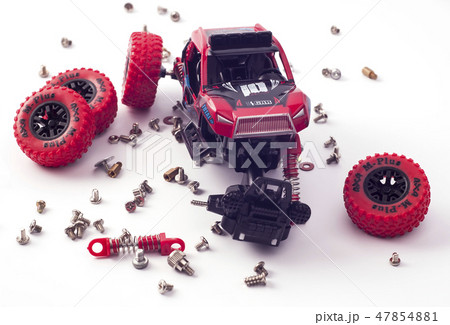 Disassembled car and scattered parts. Broken toy 47854881