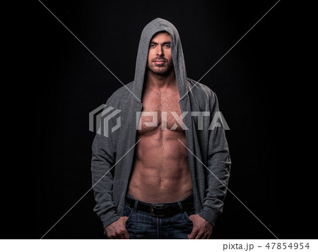 Muscular man in gray hoodie Muscular man in gray hoodie 47854954