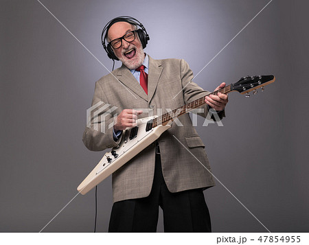 Senior man playing electric guitar Senior man playing electric guitar 47854955