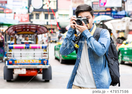 Young Asian tourist photographer taking photo Young Asian tourist photographer taking photo 47857586