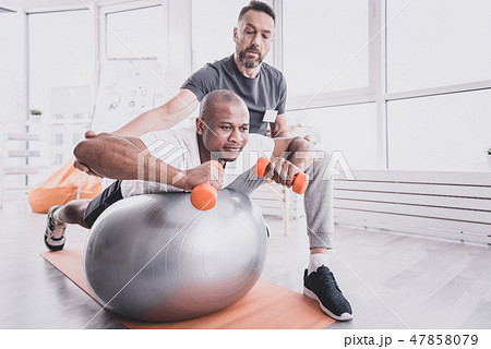 Serious therapist looking at his international client 47858079