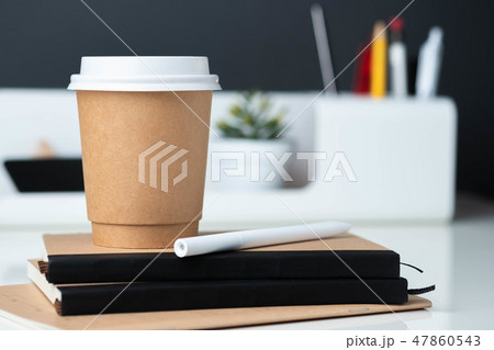 Coffee cup on notebook at modern office stationery 47860543
