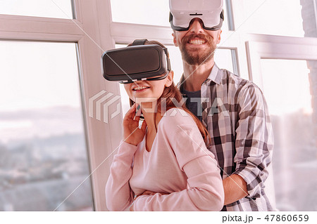 Happy man and woman standing together near the widow 47860659