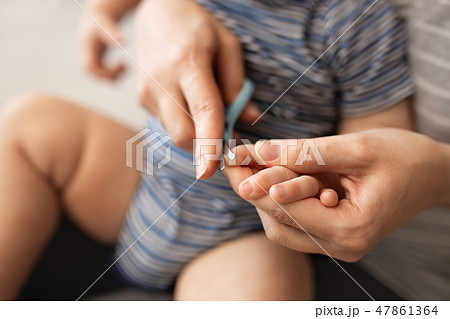 mother cutting nails for baby mother cutting nails for baby 47861364