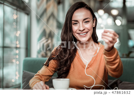 Happy young woman visiting her favorite cafeteria 47861632