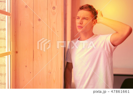 Reflective musing guy facing his inner conflict Reflective musing guy facing his inner conflict 47861661