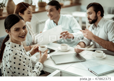 Positive delighted brunette woman looking at camera Positive delighted brunette woman looking at camera 47862375