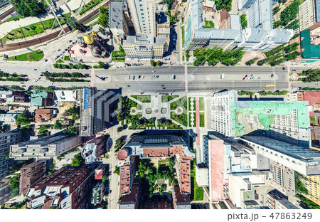 Aerial city view with crossroads and roads, houses, buildings, parks and parking lots. Sunny summer 47863249