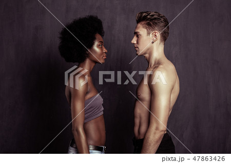 Serious young people looking at each other Serious young people looking at each other 47863426