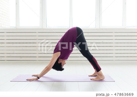 Healthy lifestyle, people and sport concept - Middle aged woman doing yoga Healthy lifestyle, people and sport concept - Middle aged woman doing yoga 47863669