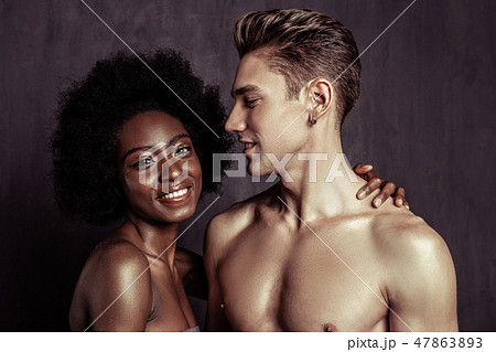 Delighted handsome fit man standing half face Delighted handsome fit man standing half face 47863893