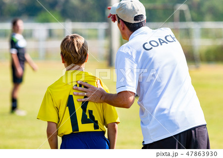 Back of male football coach in white COACH shirt 47863930