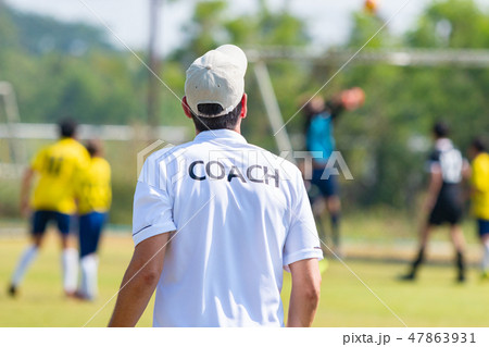 Back of male football coach in white COACH shirt 47863931
