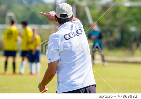Back of male football coach in white COACH shirt 47863932