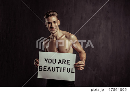 Joyful happy blonde man cheering you up 47864096