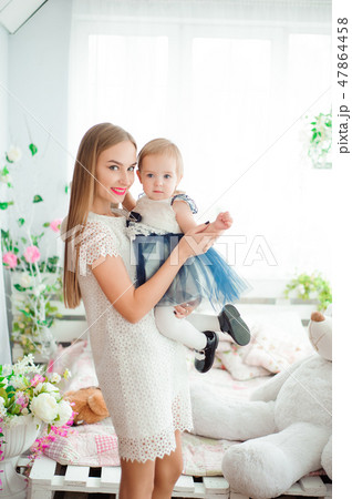 Mom hugging and kissing his little daughter 47864458