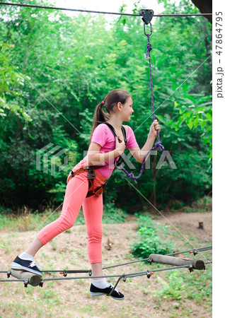 adventure climbing high wire park - hiking in the rope park girl adventure climbing high wire park - hiking in the rope park girl 47864795