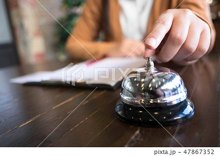 Women call hotel reception with finger push a bell Women call hotel reception with finger push a bell 47867352