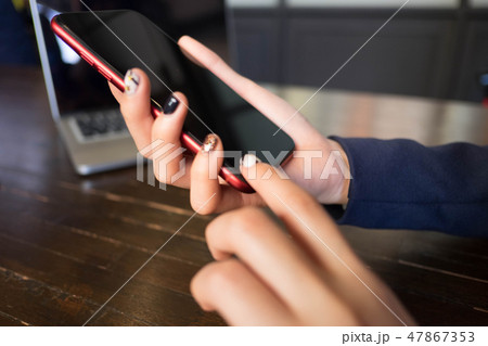 Close up of a woman using mobile smart phone. 47867353