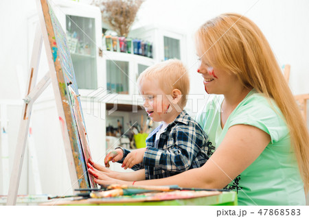 Mother and child draw a picture paints, art lesson 47868583