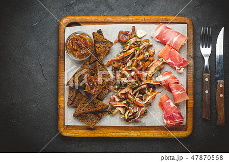 Assorted jamon and bacon on a wooden table Assorted jamon and bacon on a wooden table 47870568