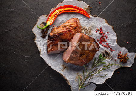 Baked meat with spices on black background 47870599