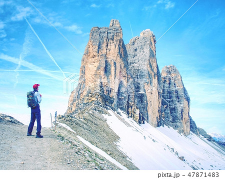 Travel Man enjoying serene view Tre Cime mountains 47871483
