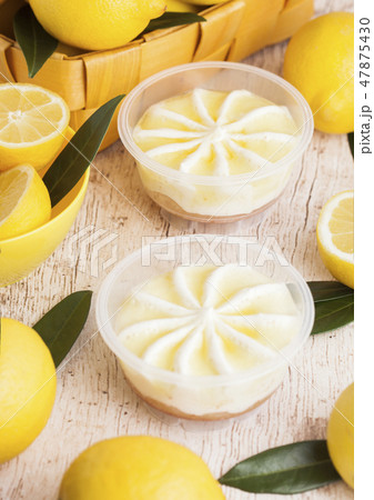 Plastic jar with lemon cheesecake mousse dessert 47875430