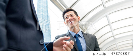 Asian Chinese businessman talking with partner Asian Chinese businessman talking with partner 47876307