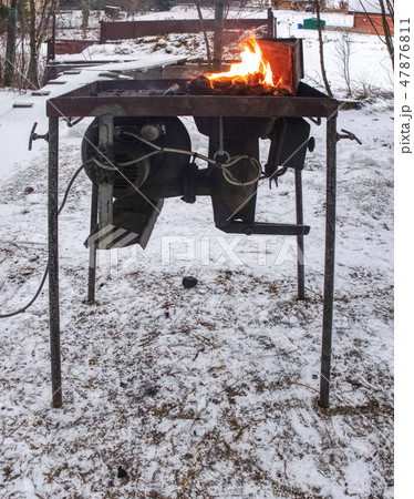 Small blacksmith's forge with horse hoof inside Small blacksmith's forge with horse hoof inside 47876811