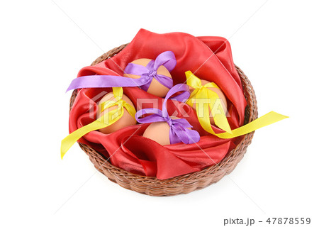 Easter eggs in a wicker basket isolated on white. Easter eggs in a wicker basket isolated on white. 47878559