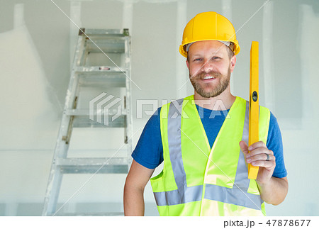 Male Contractor in Hard Hat Safety Vest and Level Male Contractor in Hard Hat Safety Vest and Level 47878677