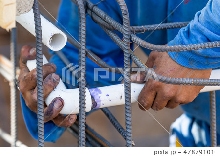 Plumber Installing PVC Pipe at Construction Site 47879101