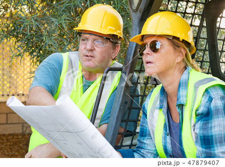 Male and Female Contractors at Construction Site 47879407