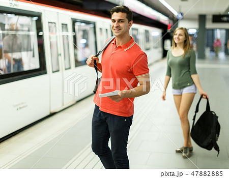 Man with his girlfriend are standing on platform and choosing route Man with his girlfriend are standing on platform and choosing route 47882885