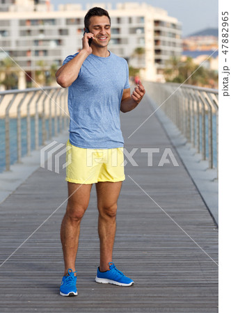 Athletic man talking by phone 47882965
