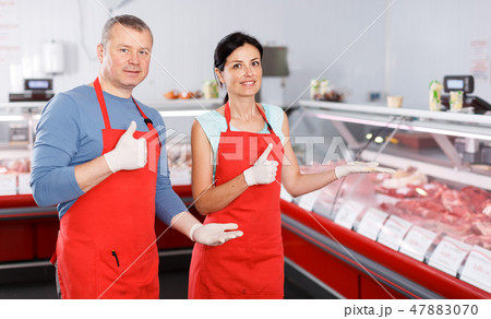 Man and woman seller offering products in shop Man and woman seller offering products in shop 47883070