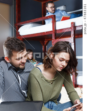 Loving couple resting in hostel bedroom Loving couple resting in hostel bedroom 47883161