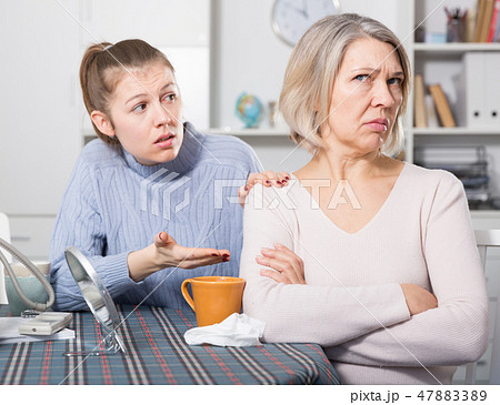 Adult daughter reassures offended mother Adult daughter reassures offended mother 47883389
