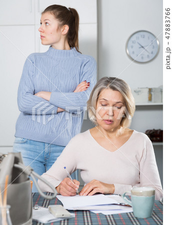 Woman quarreling with mother for documents 47883766