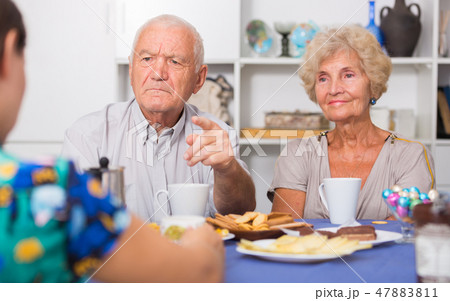 Stressed senior couple having conversation with female Stressed senior couple having conversation with female 47883811