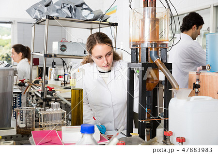 Female student working on lab equipment Female student working on lab equipment 47883983