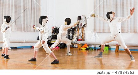 Mixed age group people at fencing workout Mixed age group people at fencing workout 47884562