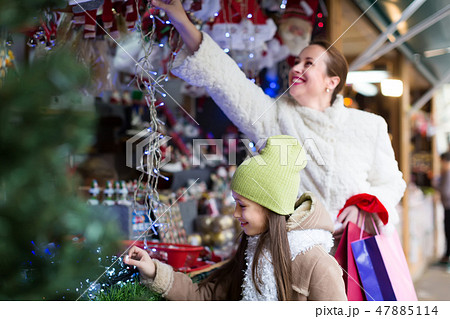 girl with mom buying decorations 47885114