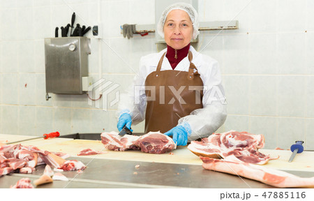 Female cutting raw meat 47885116