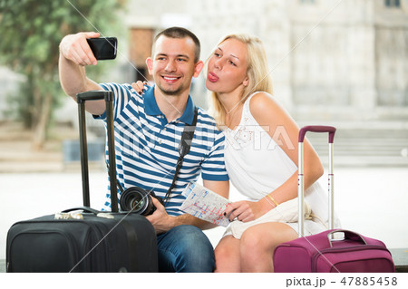 young traveling couple taking selfie. young traveling couple taking selfie. 47885458