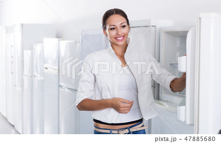 Woman selecting domestic refrigerator 47885680